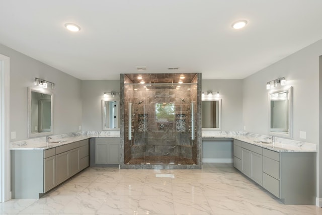 bathroom with a stall shower, marble finish floors, and two vanities