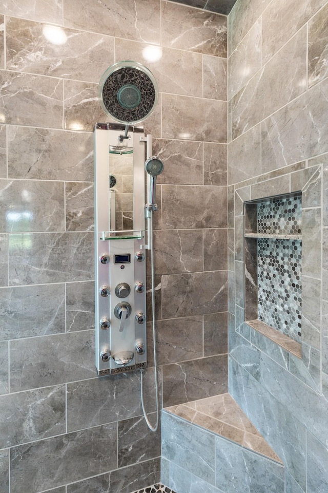 bathroom with tiled shower