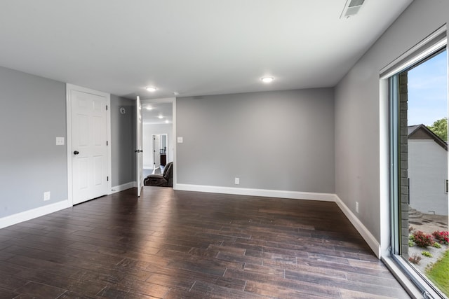 spare room featuring wood finished floors, baseboards, and recessed lighting
