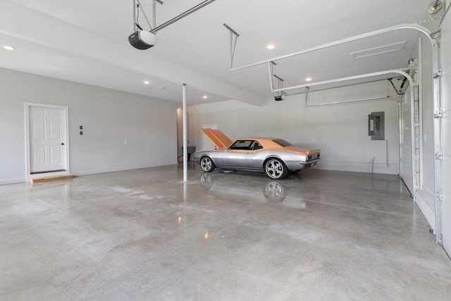 garage with electric panel, recessed lighting, a garage door opener, and baseboards