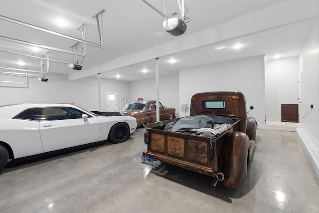 garage with a garage door opener and recessed lighting