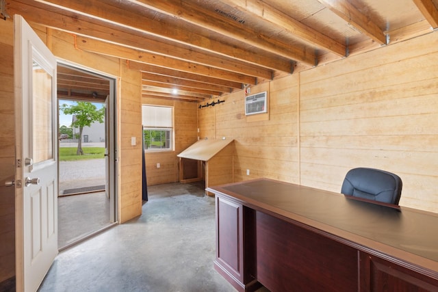 office space featuring concrete floors and wooden walls