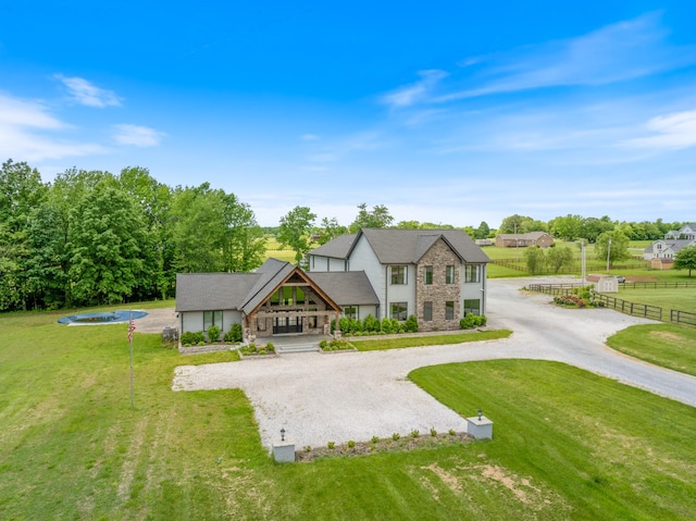 view of front of property with stone siding, curved driveway, and a porch