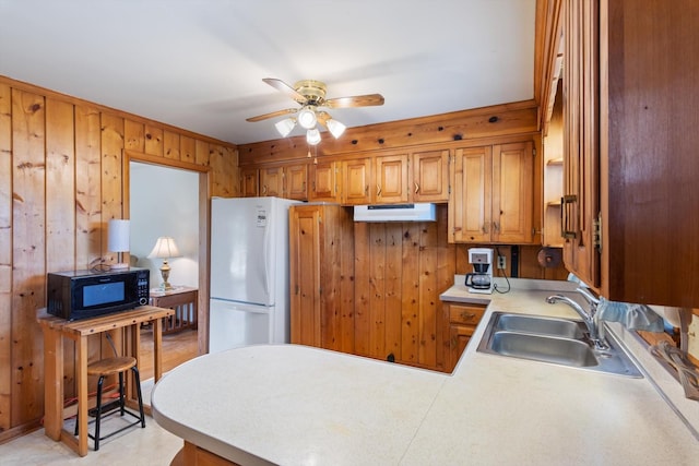 461 Annex Ave, Nashville, TN 37209 - kitchen with black microwave, a sink, freestanding refrigerator, wood walls, and ceiling fan