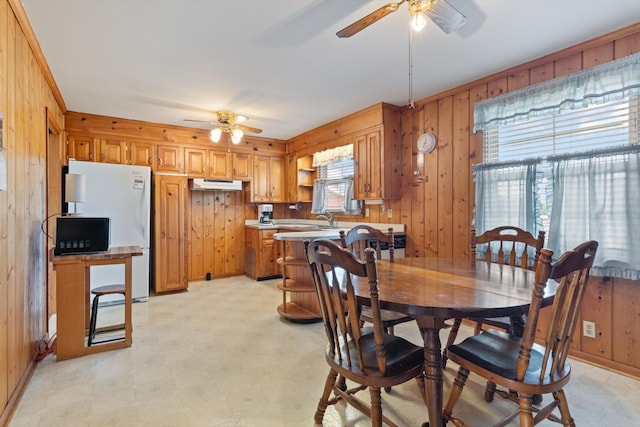 461 Annex Ave, Nashville, TN 37209 - dining space with a ceiling fan, wooden walls, and light floors