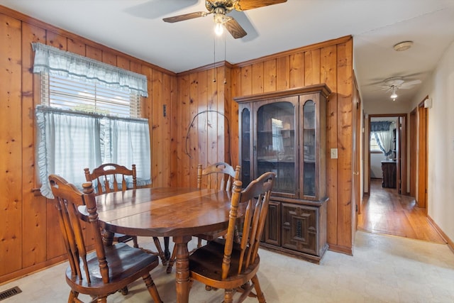 461 Annex Ave, Nashville, TN 37209 - dining space with ceiling fan, light flooring, and wooden walls