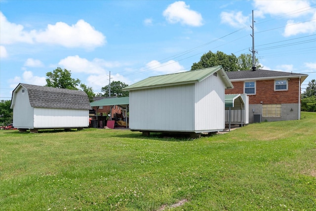 461 Annex Ave, Nashville, TN 37209 - view of grassy yard with a storage unit and an outbuilding