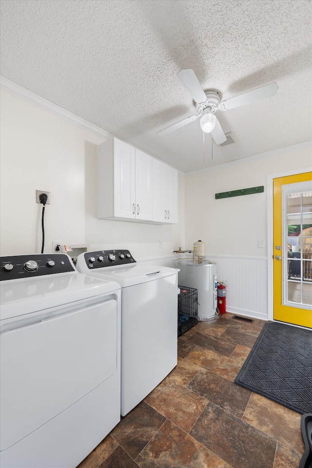 1120 Weeks Rd, Murfreesboro, TN 37127 - laundry room with washing machine and clothes dryer, a textured ceiling, a ceiling fan, cabinet space, and dark stone finish flooring