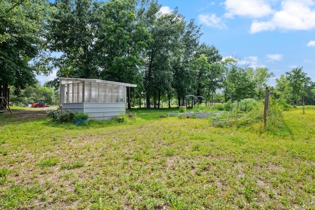 1120 Weeks Rd, Murfreesboro, TN 37127 - view of grassy yard featuring a garden, an outbuilding, and view of scattered trees