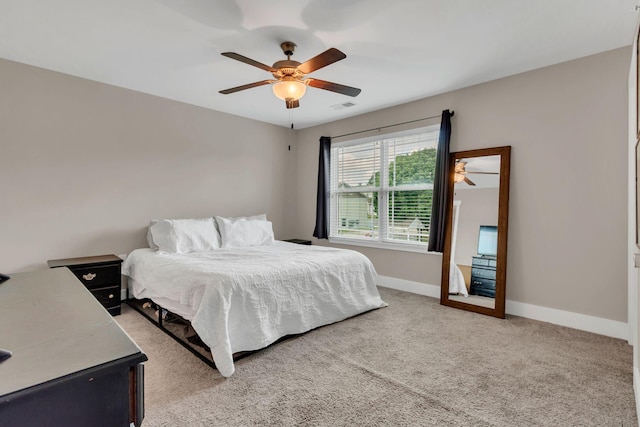 bedroom featuring light carpet, baseboards, and ceiling fan