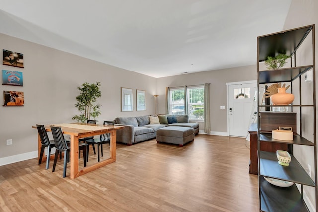 living room with light wood finished floors and baseboards