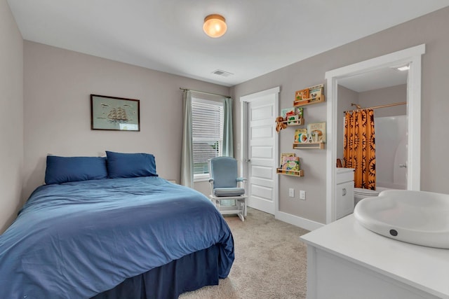bedroom with light carpet and baseboards