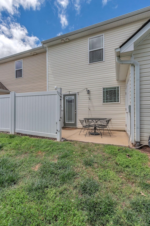 back of house with a patio