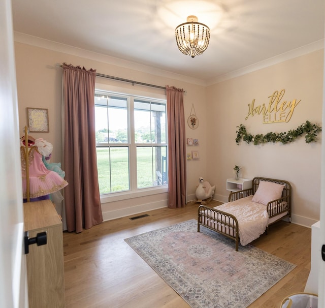 1325 Rogers Ln, Lebanon, TN 37087 - bedroom featuring ornamental molding, a chandelier, light wood-style floors, and baseboards
