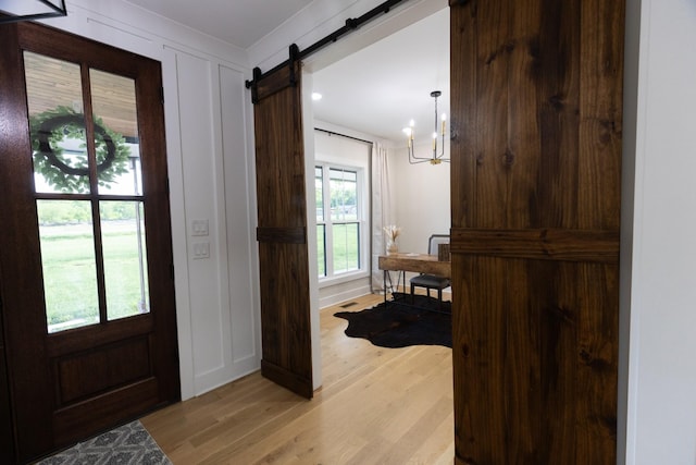 1325 Rogers Ln, Lebanon, TN 37087 - entrance foyer featuring a barn door, light wood finished floors, a chandelier, and recessed lighting