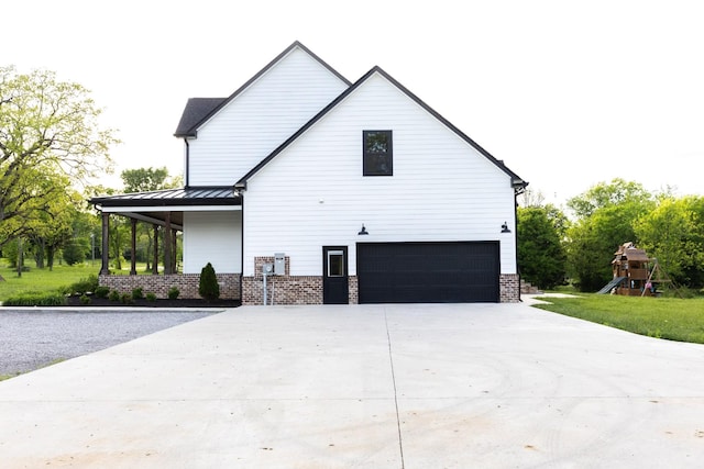 1325 Rogers Ln, Lebanon, TN 37087 - view of property exterior featuring a garage, concrete driveway, and a playground
