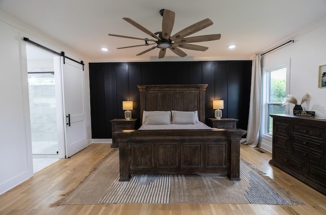 1325 Rogers Ln, Lebanon, TN 37087 - bedroom with a barn door, light wood finished floors, a ceiling fan, and recessed lighting