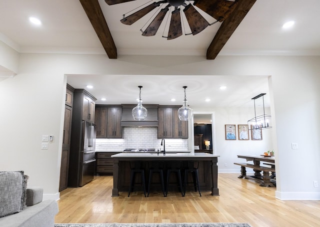 1325 Rogers Ln, Lebanon, TN 37087 - kitchen with appliances with stainless steel finishes, a sink, a breakfast bar, light wood-style flooring, and beamed ceiling