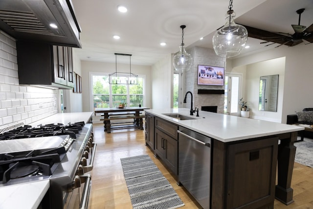 1325 Rogers Ln, Lebanon, TN 37087 - kitchen featuring stainless steel appliances, a sink, ventilation hood, recessed lighting, and a large fireplace