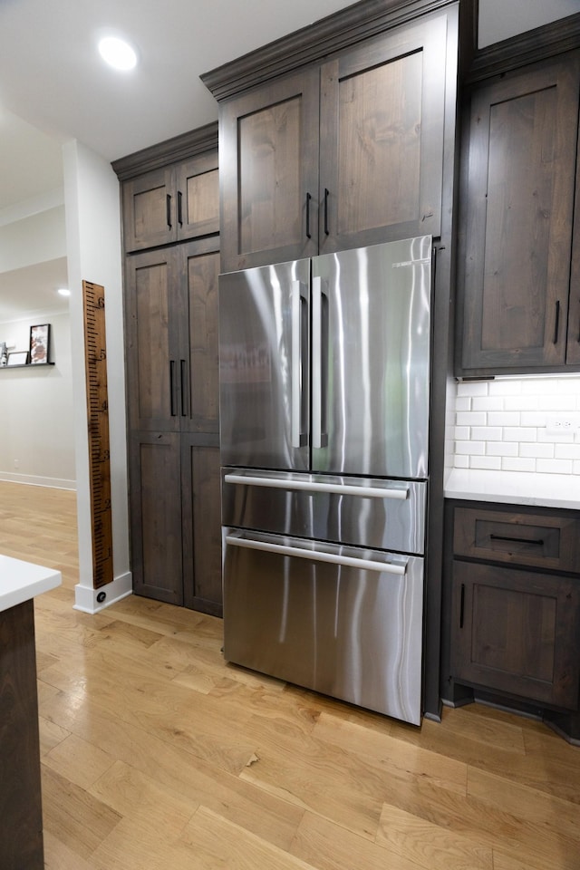 1325 Rogers Ln, Lebanon, TN 37087 - kitchen with freestanding refrigerator, dark brown cabinetry, light wood finished floors, light countertops, and recessed lighting