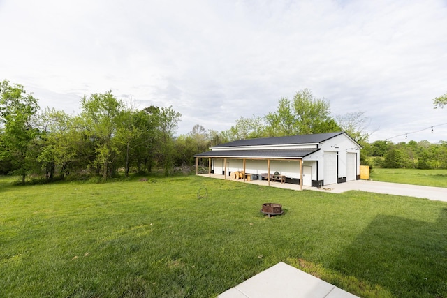 1325 Rogers Ln, Lebanon, TN 37087 - view of green lawn with an outdoor fire pit and an outdoor structure