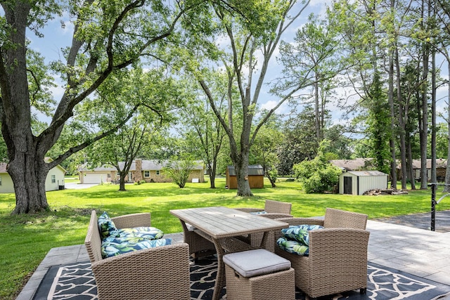 112 Churchill Pl, Franklin, TN 37067 - view of patio featuring a storage unit, an outdoor structure, and outdoor dining space