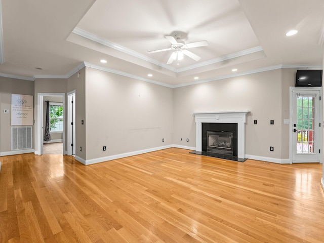 416 Overlook Cir, Tullahoma, TN 37388 - unfurnished living room with a raised ceiling, plenty of natural light, a ceiling fan, light wood finished floors, and crown molding