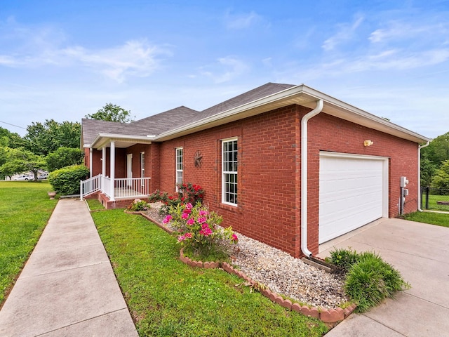 416 Overlook Cir, Tullahoma, TN 37388 - view of front of house featuring covered porch, a front yard, an attached garage, brick siding, and concrete driveway