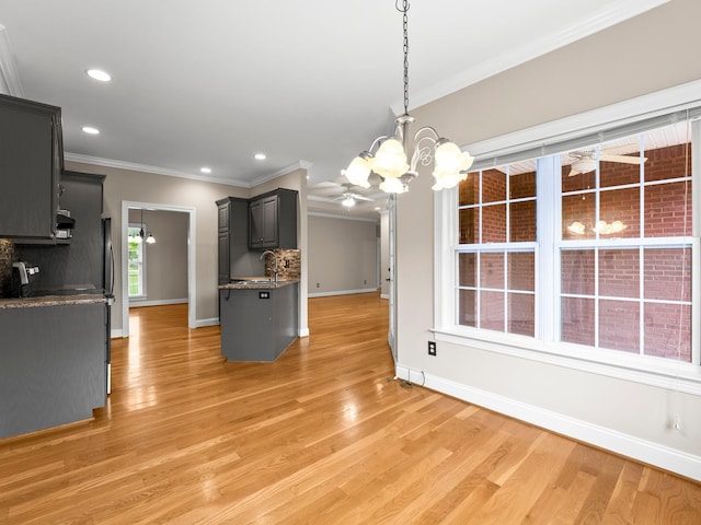 416 Overlook Cir, Tullahoma, TN 37388 - kitchen featuring a chandelier, crown molding, baseboards, light wood finished floors, and a sink