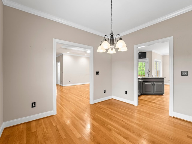 416 Overlook Cir, Tullahoma, TN 37388 - unfurnished dining area with crown molding, light wood-style floors, a chandelier, baseboards, and a sink