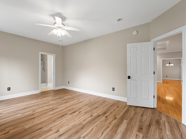 416 Overlook Cir, Tullahoma, TN 37388 - empty room with a ceiling fan, light wood-type flooring, a chandelier, baseboards, and a smoke detector