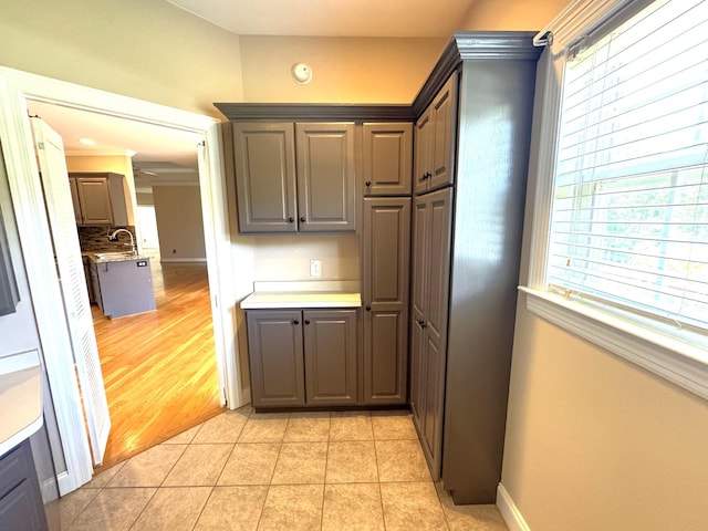 416 Overlook Cir, Tullahoma, TN 37388 - kitchen with gray cabinetry, baseboards, light countertops, and a sink