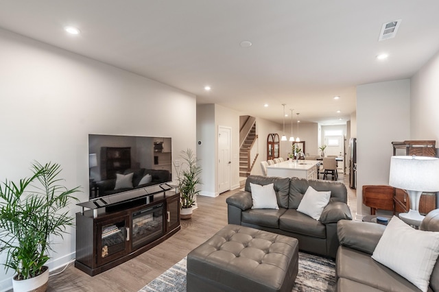 124 Great Falls Ct, Gallatin, TN 37066 - living room featuring stairway, recessed lighting, light wood-type flooring, and baseboards