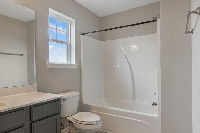 bathroom with toilet, vanity, and shower / bath combination