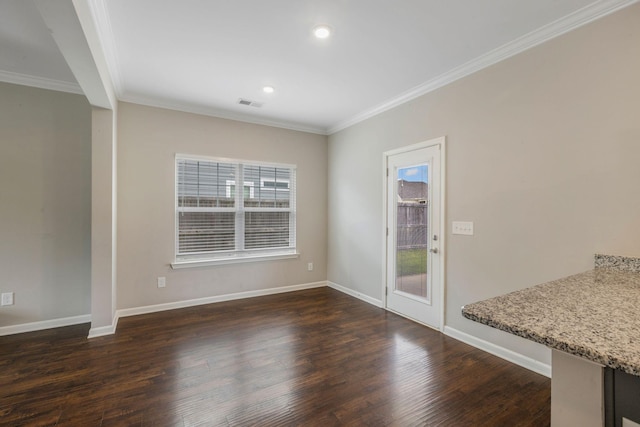 unfurnished dining area featuring crown molding, dark wood finished floors, baseboards, and recessed lighting