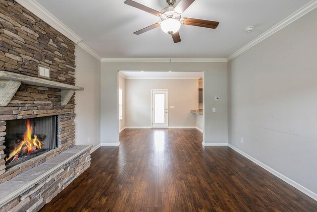unfurnished living room with wood finished floors, crown molding, a fireplace, a ceiling fan, and baseboards