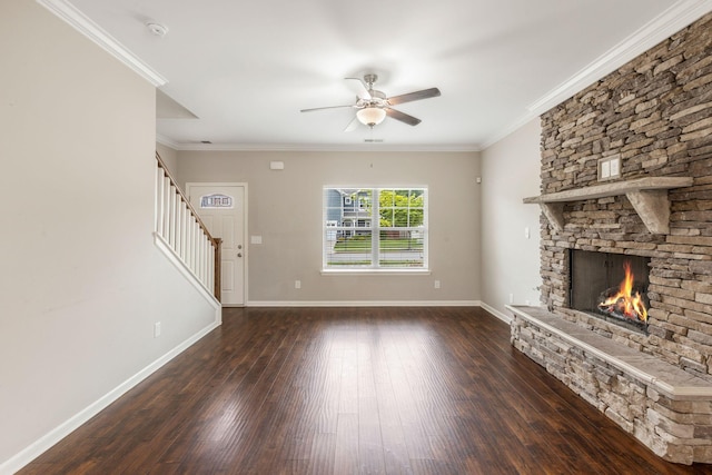 unfurnished living room featuring a ceiling fan, hardwood / wood-style flooring, stairs, a fireplace, and ornamental molding