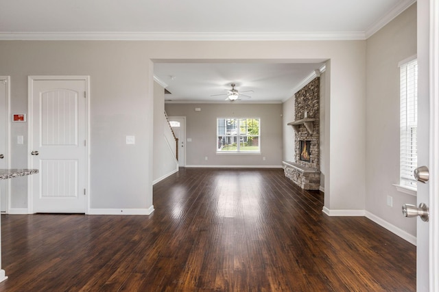 unfurnished living room with dark wood-type flooring, stairway, a fireplace, ceiling fan, and baseboards