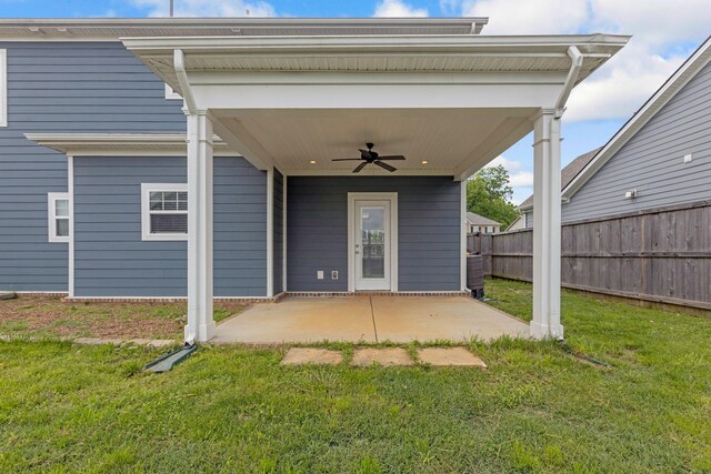 back of house with ceiling fan and a patio