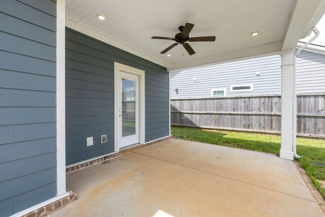 view of patio featuring ceiling fan and fence