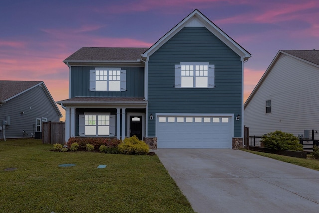 view of front of property with board and batten siding, stone siding, a garage, concrete driveway, and central AC