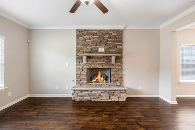 unfurnished living room featuring ceiling fan, ornamental molding, wood finished floors, a fireplace, and baseboards