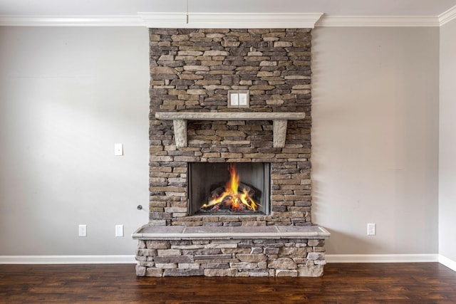 detailed view of wood finished floors, crown molding, a fireplace, and baseboards
