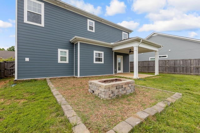 rear view of house featuring a ceiling fan and a patio