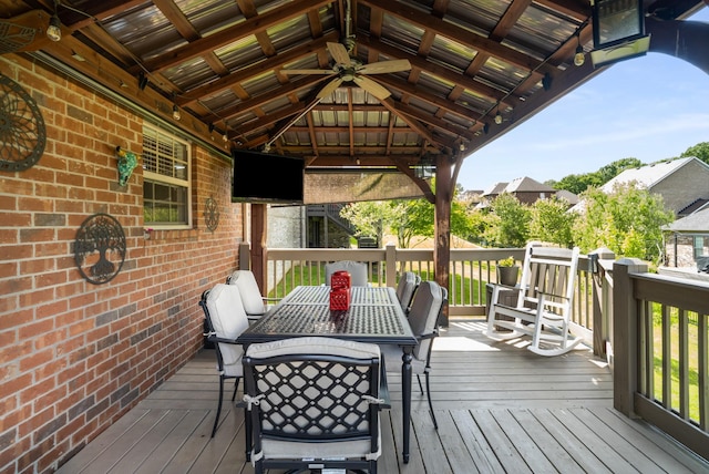 wooden deck featuring a gazebo and outdoor dining area