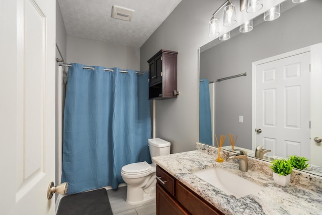 full bathroom featuring toilet, a textured ceiling, vanity, curtained shower, and tile patterned floors