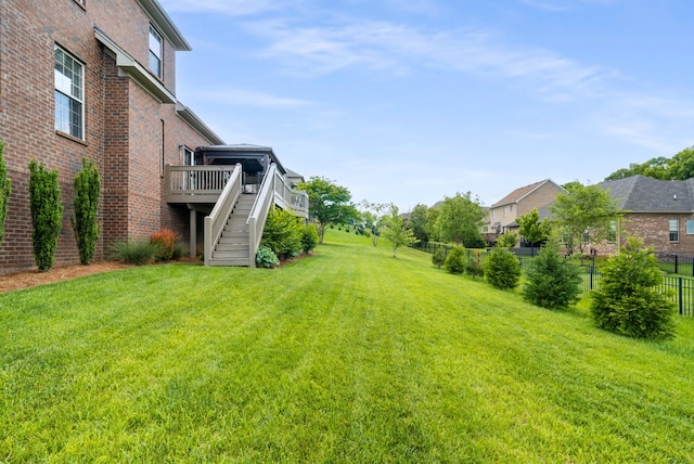 view of yard with stairs and a wooden deck