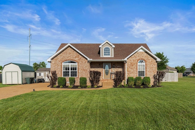 158 Cornerstone Blvd, Portland, TN 37148 - view of front of property featuring a storage shed, brick siding, an outbuilding, and roof with shingles