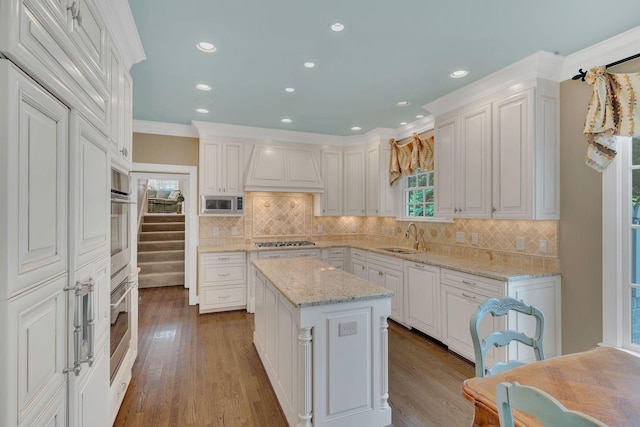 kitchen with premium range hood, stainless steel appliances, backsplash, white cabinets, and recessed lighting