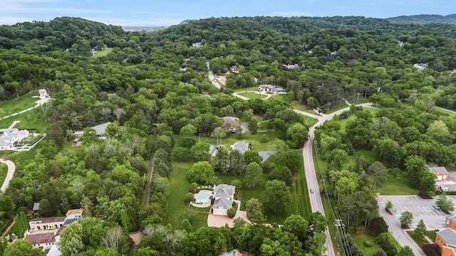 view of property location featuring a forest